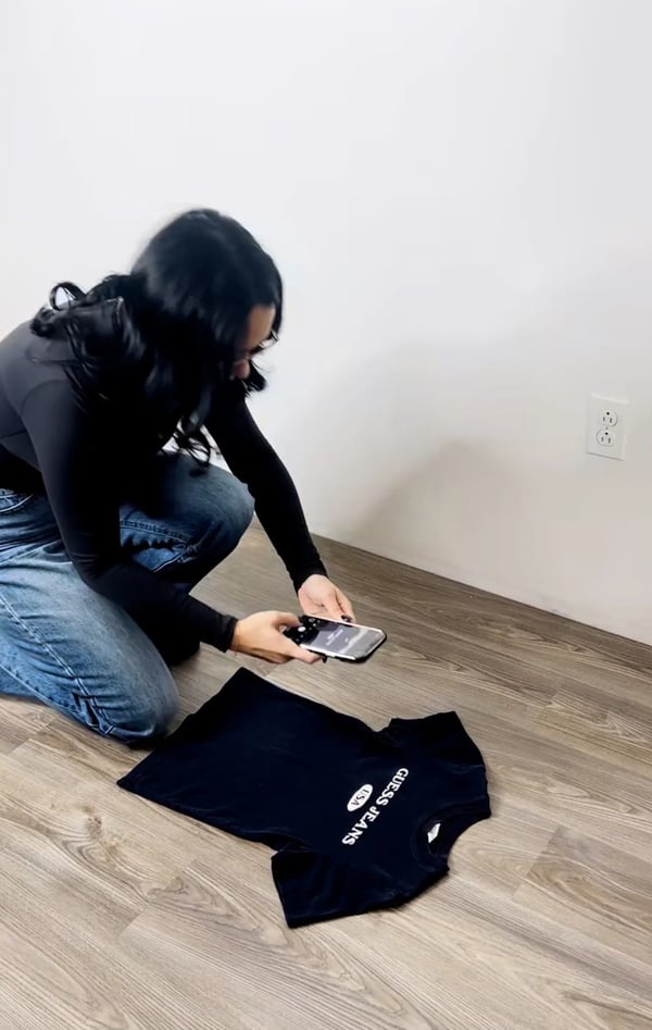 Erynn taking a picture of a t shirt to upload to one of the best sites to sell them